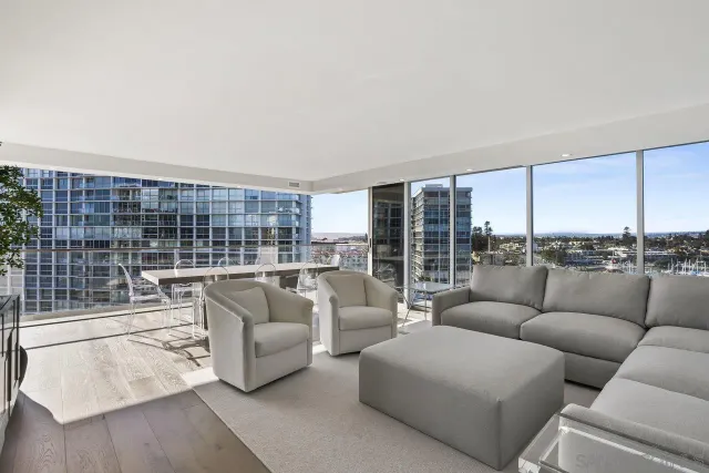 a living room with furniture and a floor to ceiling window