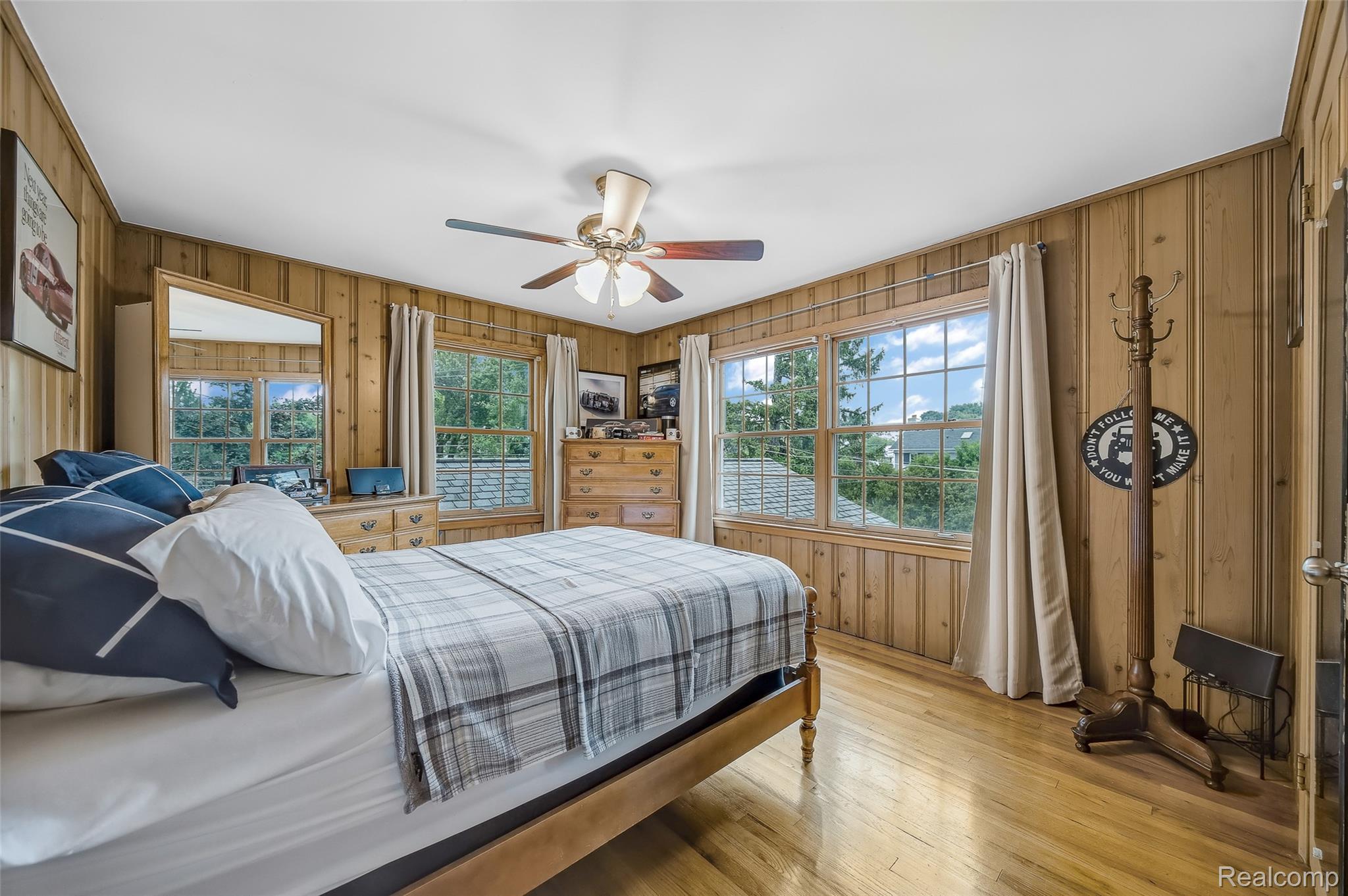 100 Overhill Road Bloomfield Hills, MI 48301 - Photo 25 of 55 Bedroom featuring wooden walls, light wood-style floors, and ceiling fan