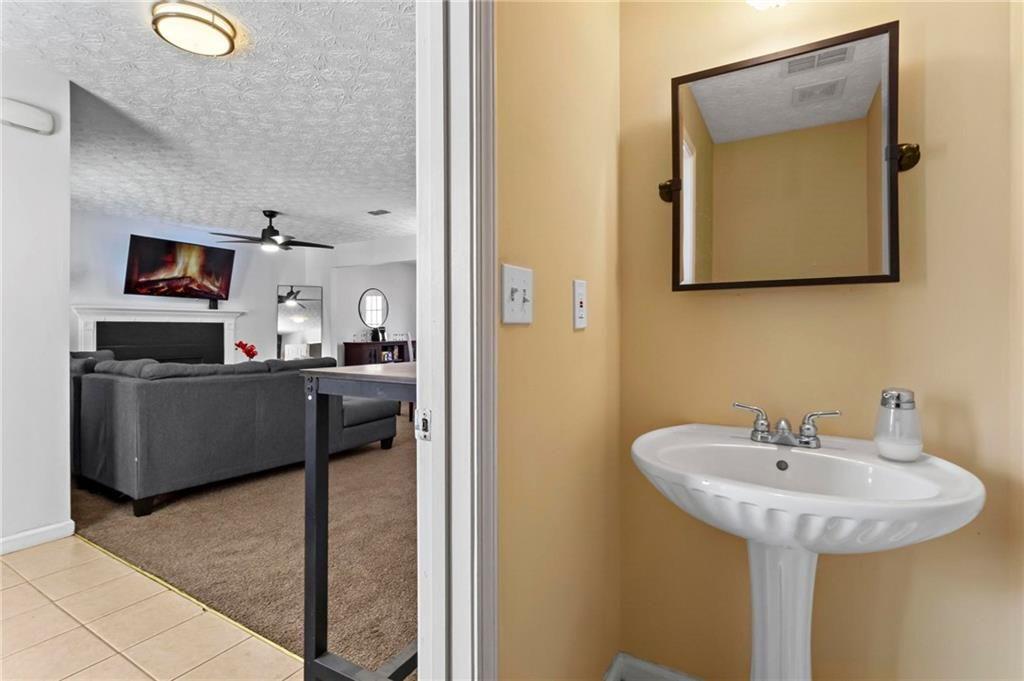 392 4th Street Forest Park, GA 30297 - Photo 11 of 21 a en suite bathroom with a sink and mirror