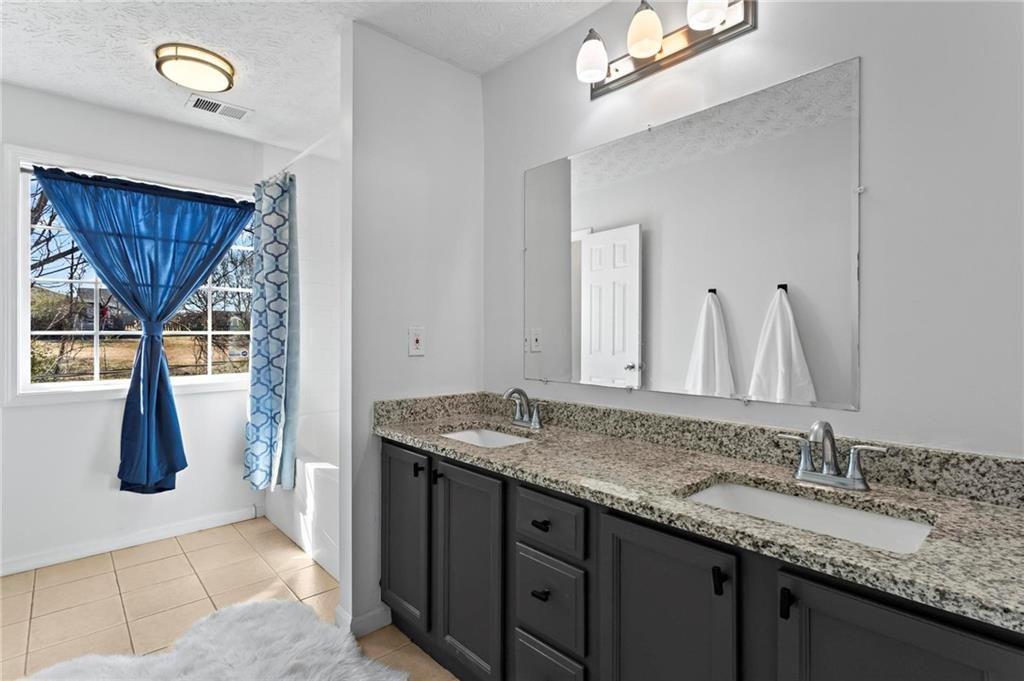 392 4th Street Forest Park, GA 30297 - Photo 14 of 21 a bathroom with a granite countertop sink and a mirror
