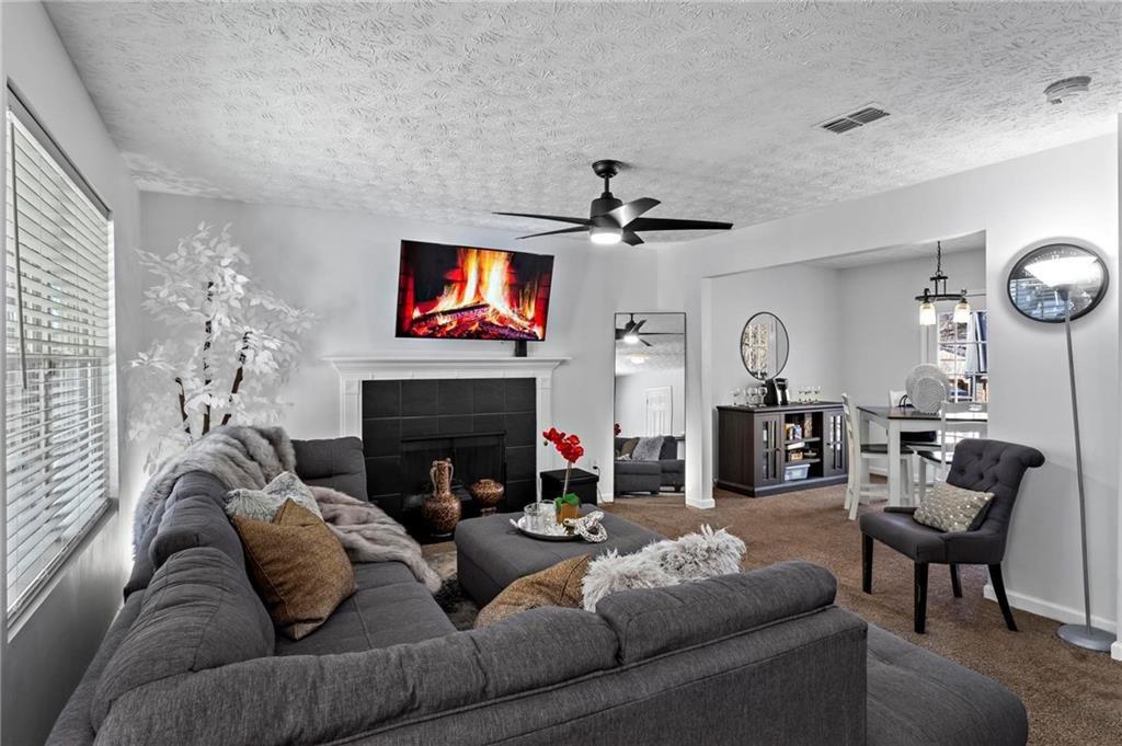 392 4th Street Forest Park, GA 30297 - Photo 4 of 21 a living room with furniture a flat screen tv and a fireplace