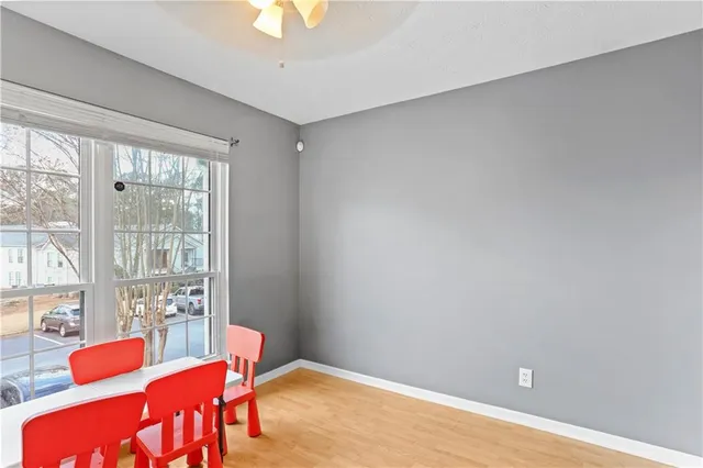 a view of living room kitchen with stainless steel appliances furniture and a window