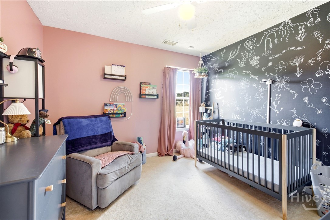 121 Crestview Drive Carnesville, GA 30521 - Photo 19 of 28 Room with light pink walls and a chalkboard-style accent wall featuring white floral drawings