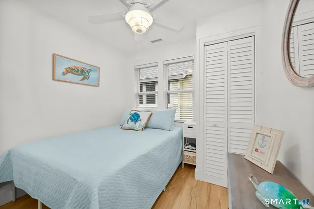 a spacious bedroom with a bed and a window