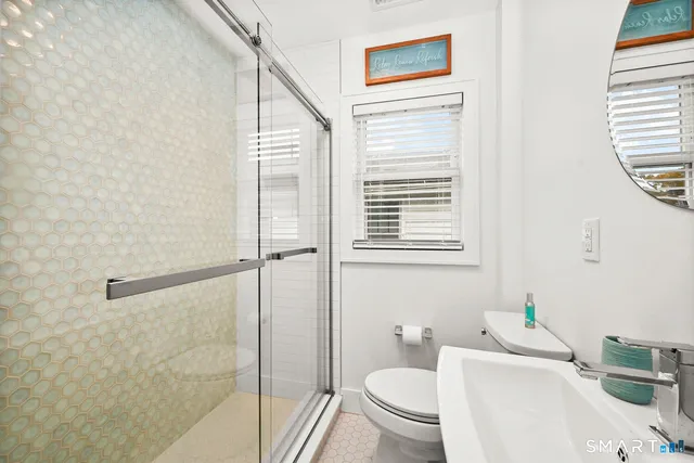 a bathroom with a toilet and a shower curtain