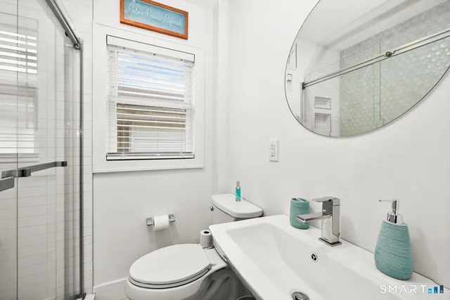 a bathroom with a sink a mirror and a toilet