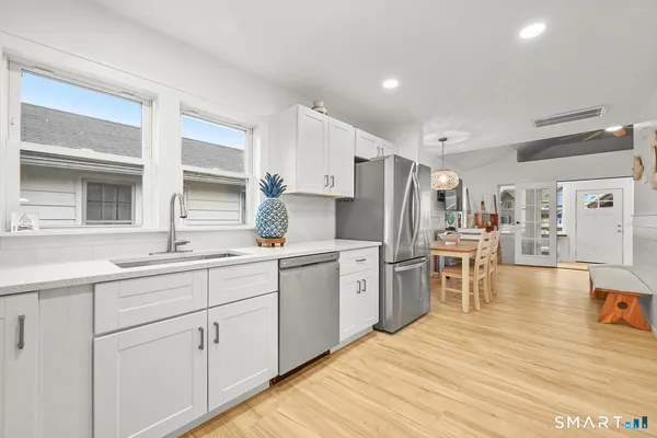 a kitchen with granite countertop a stove and a sink