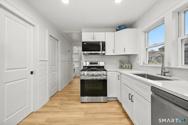 a view of a livingroom with furniture and wooden floor