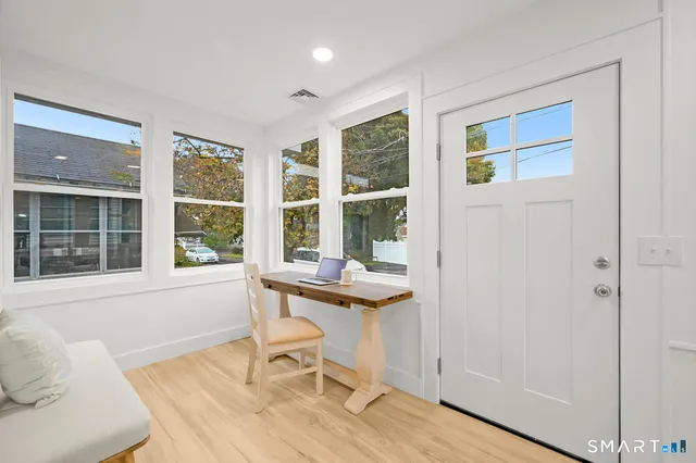 a view of a dining room with furniture and windows