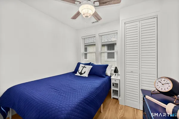 a spacious bedroom with a bed and a window