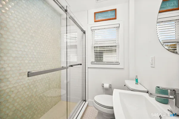 a bathroom with a sink a mirror and a toilet