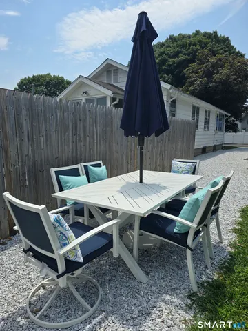 a backyard of a house with table and chairs