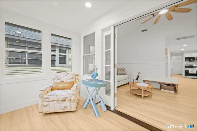 a living room with furniture and wooden floor