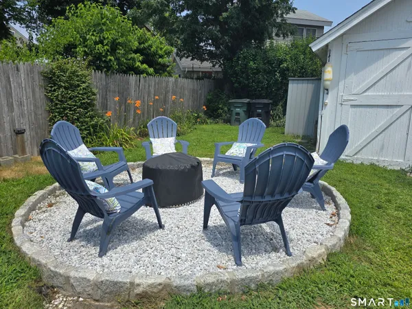 a view of a house with backyard sitting area and garden