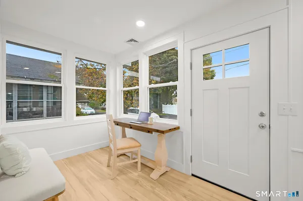 a living room with furniture and wooden floor
