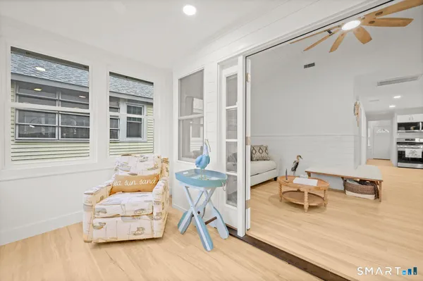 a bedroom with furniture and large window
