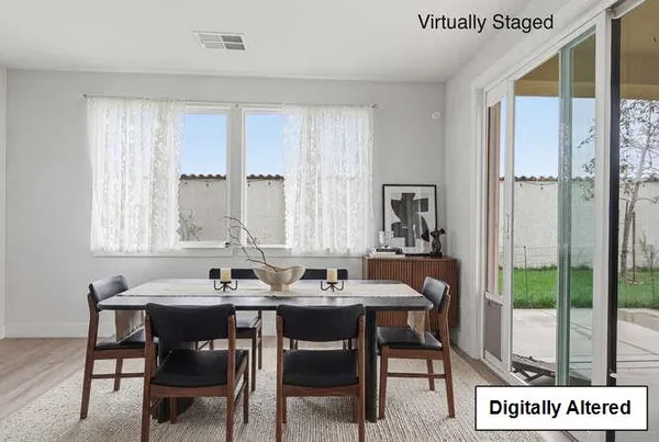 a view of a dining room with furniture and window