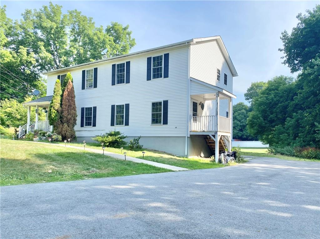 a view of a house with a swimming pool and a yard
