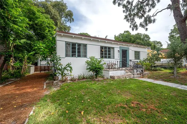 a view of a house with a yard and a garden