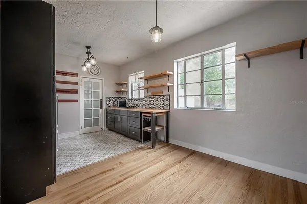 a kitchen with stainless steel appliances a stove and wooden floor