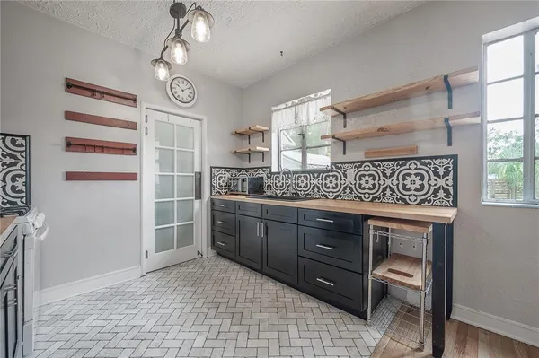 a kitchen with stainless steel appliances granite countertop a sink and cabinets