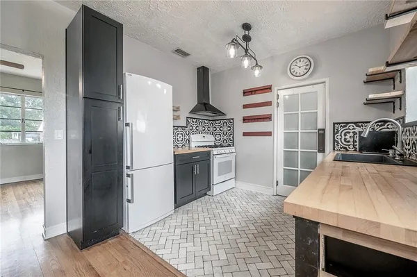 a kitchen with granite countertop a stove and a refrigerator