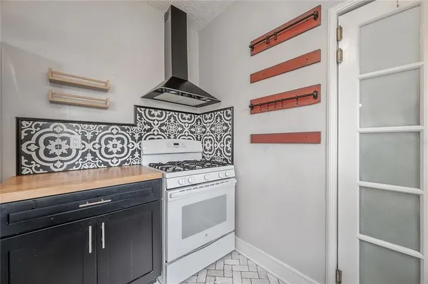 a view of a kitchen with stove and cabinets
