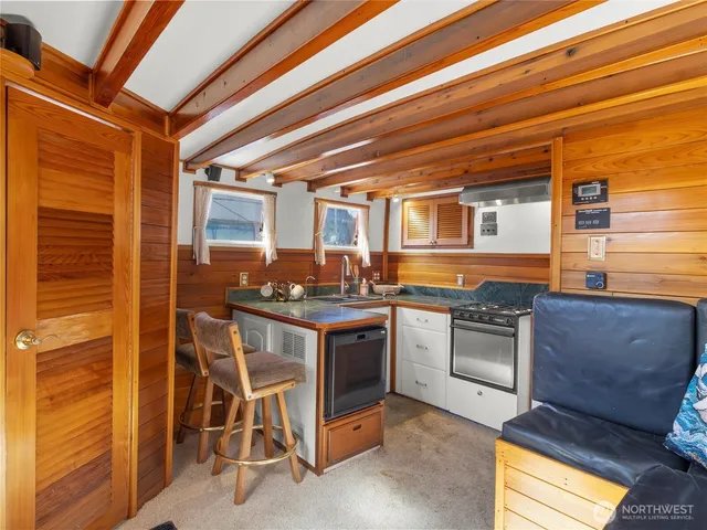 a kitchen with sink stove and cabinets