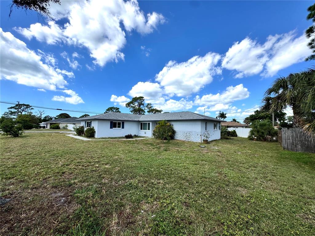 1048 Porpoise Road Venice, FL 34293 - Photo 25 of 26 a view of a house with a big yard and a large tree