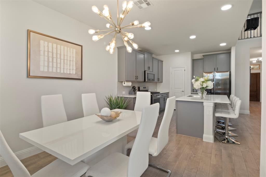 4125 Fern Loop Forney, TX 75126 - Photo 12 of 40 Open-concept living area with wood-finish flooring, recessed lighting, and a modern chandelier