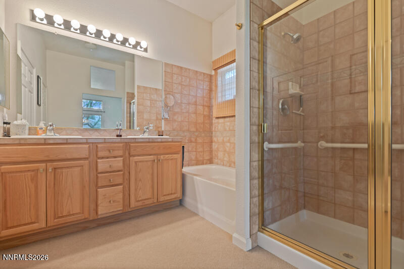 403 Sierra Leaf Circle Reno, NV 89511 - Photo 15 of 25 a bathroom with a double vanity sink a toilet a mirror and shower