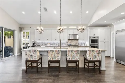 a large kitchen with stainless steel appliances kitchen island a large center island and a stove top oven