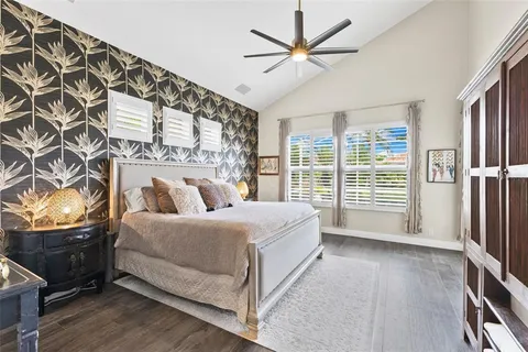 a bedroom with a bed and a chandelier