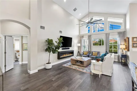 a living room with furniture and wooden floor