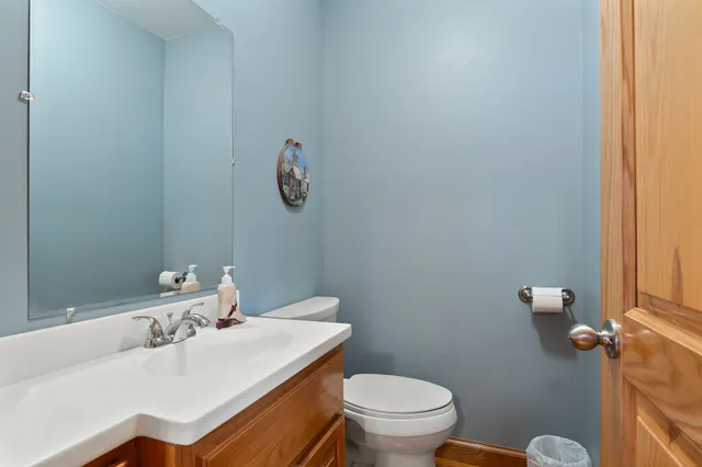 a bathroom with a sink a toilet and mirror