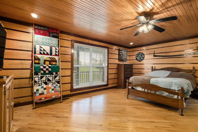 a bedroom with furniture and a large window