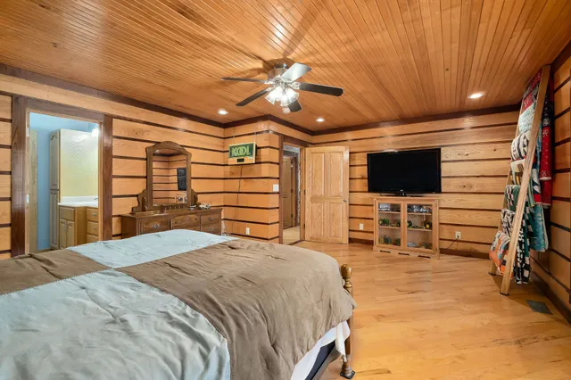 a bedroom with a bed and a flat screen tv