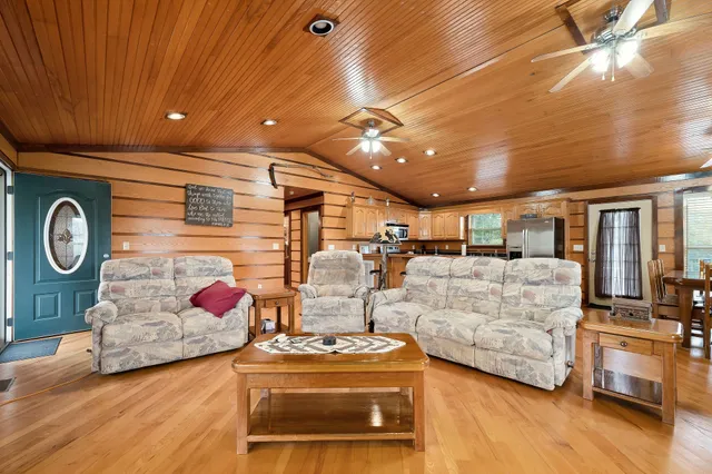 a living room with furniture and kitchen view