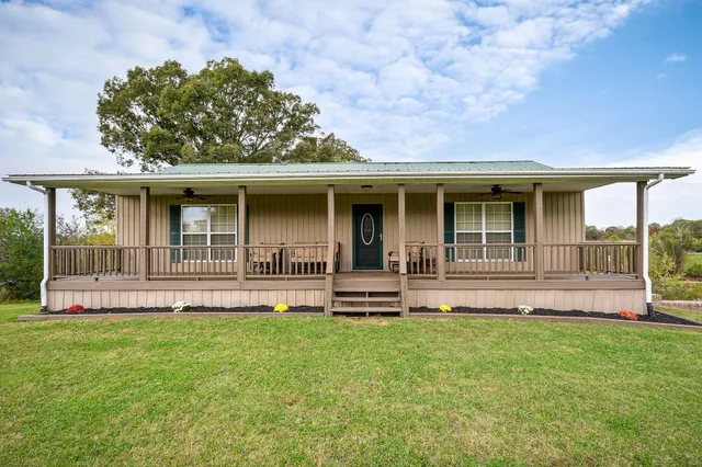 a front view of a house with a garden and yard