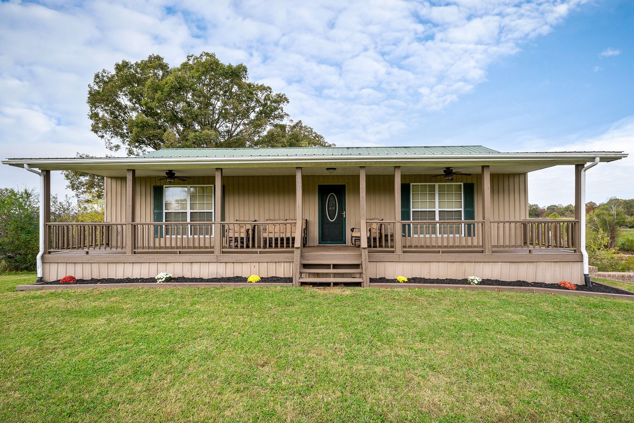 1195 Highland Avenue Baxter, TN 38544 - Photo 29 of 33 a front view of a house with a garden and yard