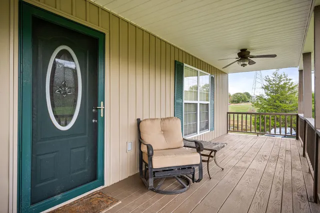 a view of a balcony with furniture and wooden floor