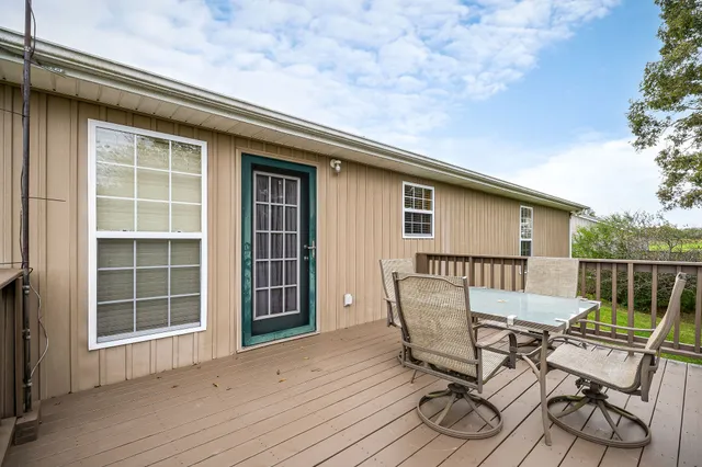 a view of backyard with furniture and wooden floor