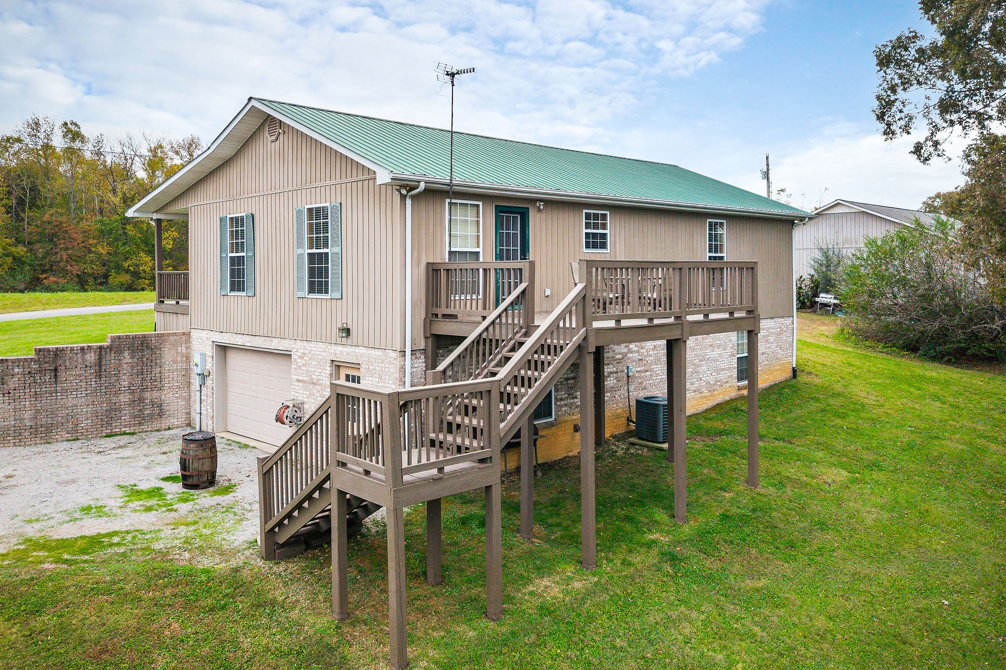 1195 Highland Avenue Baxter, TN 38544 - Photo 4 of 33 a roof deck with table and chairs under an umbrella