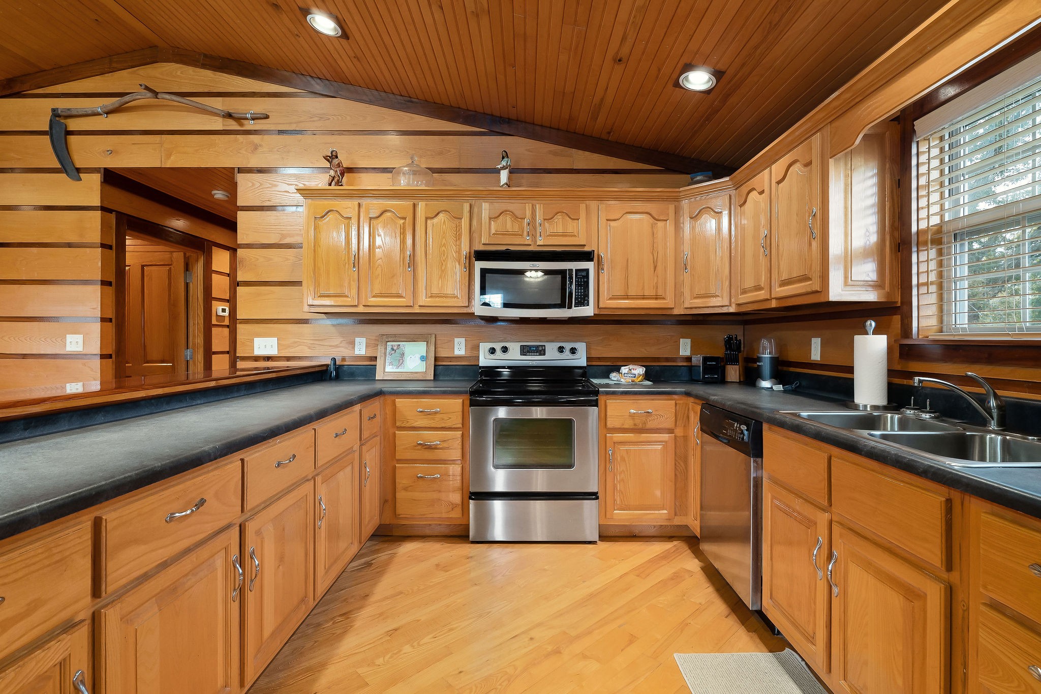 1195 Highland Avenue Baxter, TN 38544 - Photo 6 of 33 a kitchen with granite countertop a stove top oven a sink dishwasher and a microwave oven with cabinets