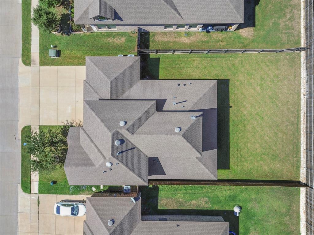 4125 Fern Loop Forney, TX 75126 - Photo 35 of 40 Pitched shingle roof with multiple gables, extensive concrete driveway, and a fenced perimeter
