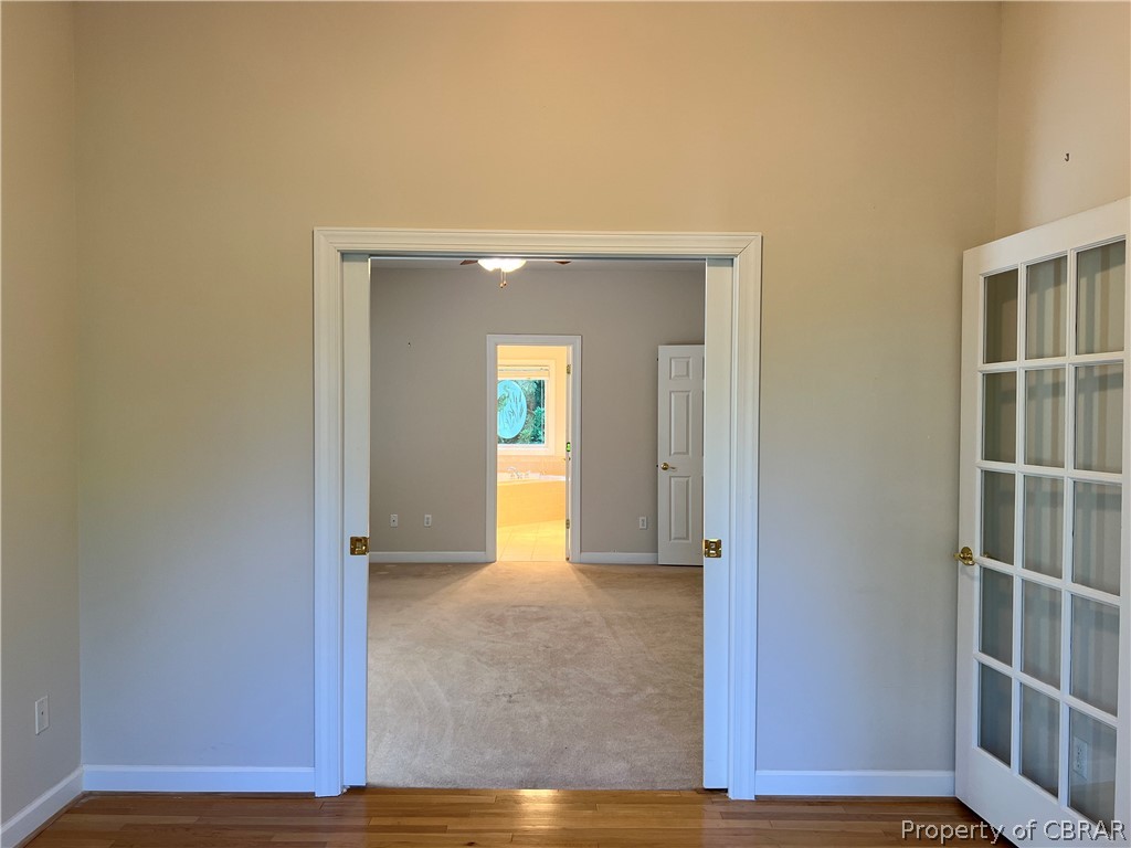 48 Fairfield Road Hartfield, VA 23071 - Photo 10 of 34 The Den also accesses the Primary Suite with Pocket Doors