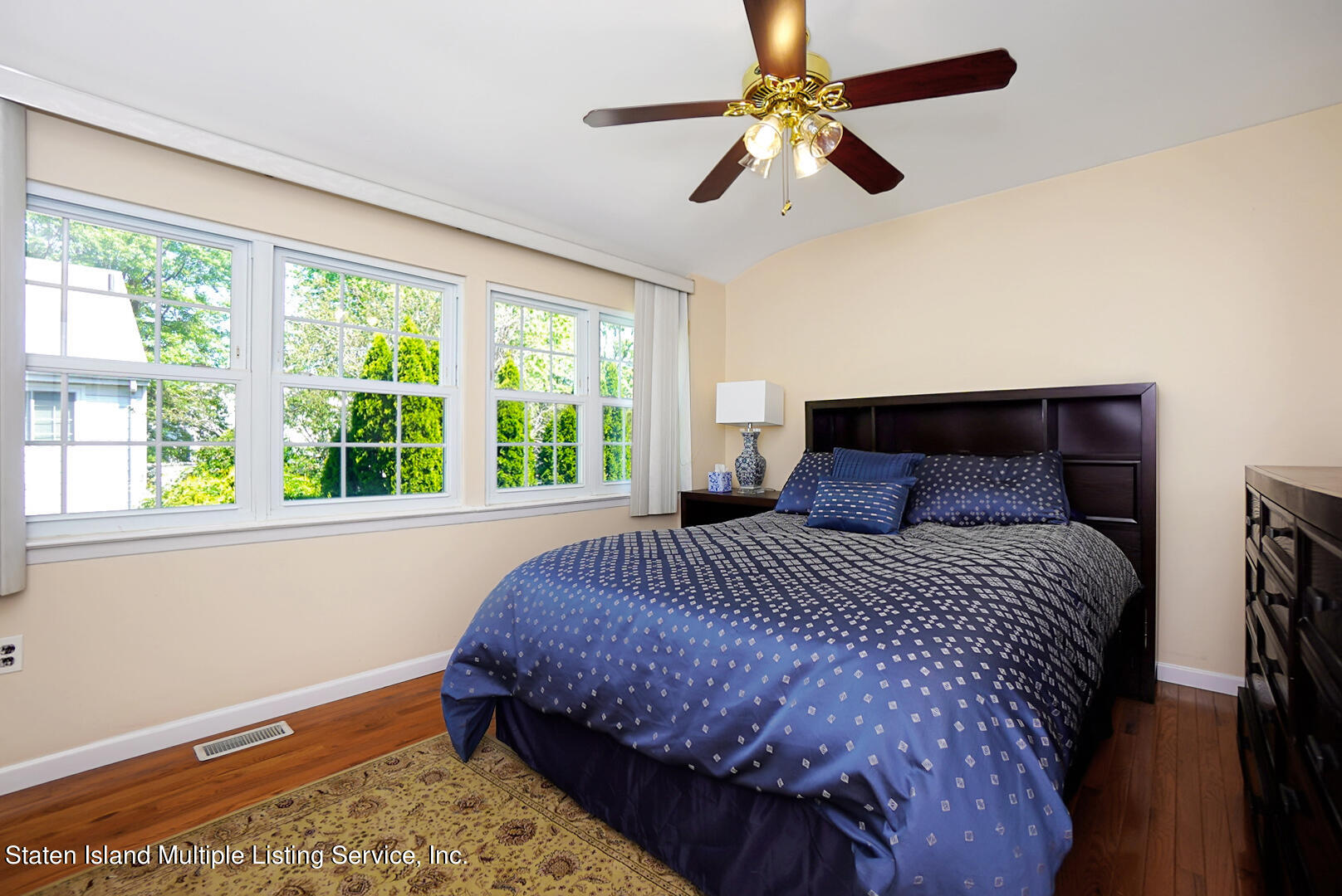 96 Hampton Green Staten Island, NY 10312 - Photo 13 of 24 a bedroom with a bed chandelier and a window