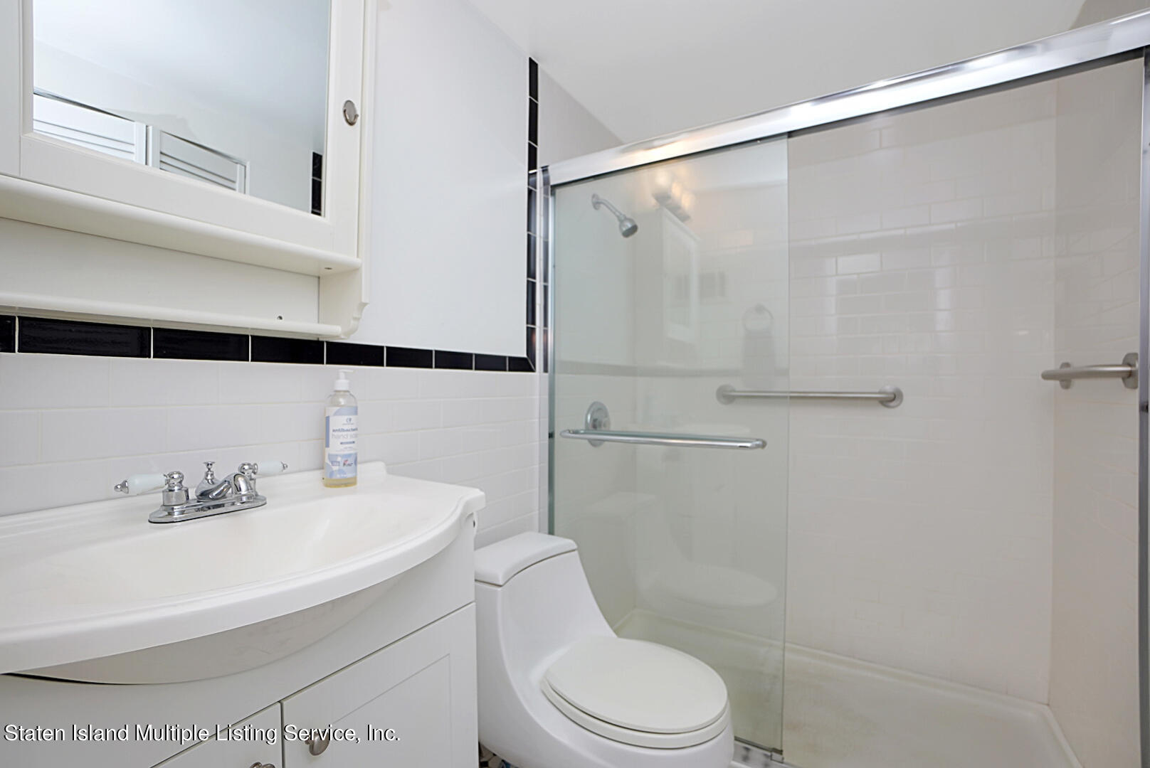 96 Hampton Green Staten Island, NY 10312 - Photo 15 of 24 a bathroom with a sink mirror shower and toilet