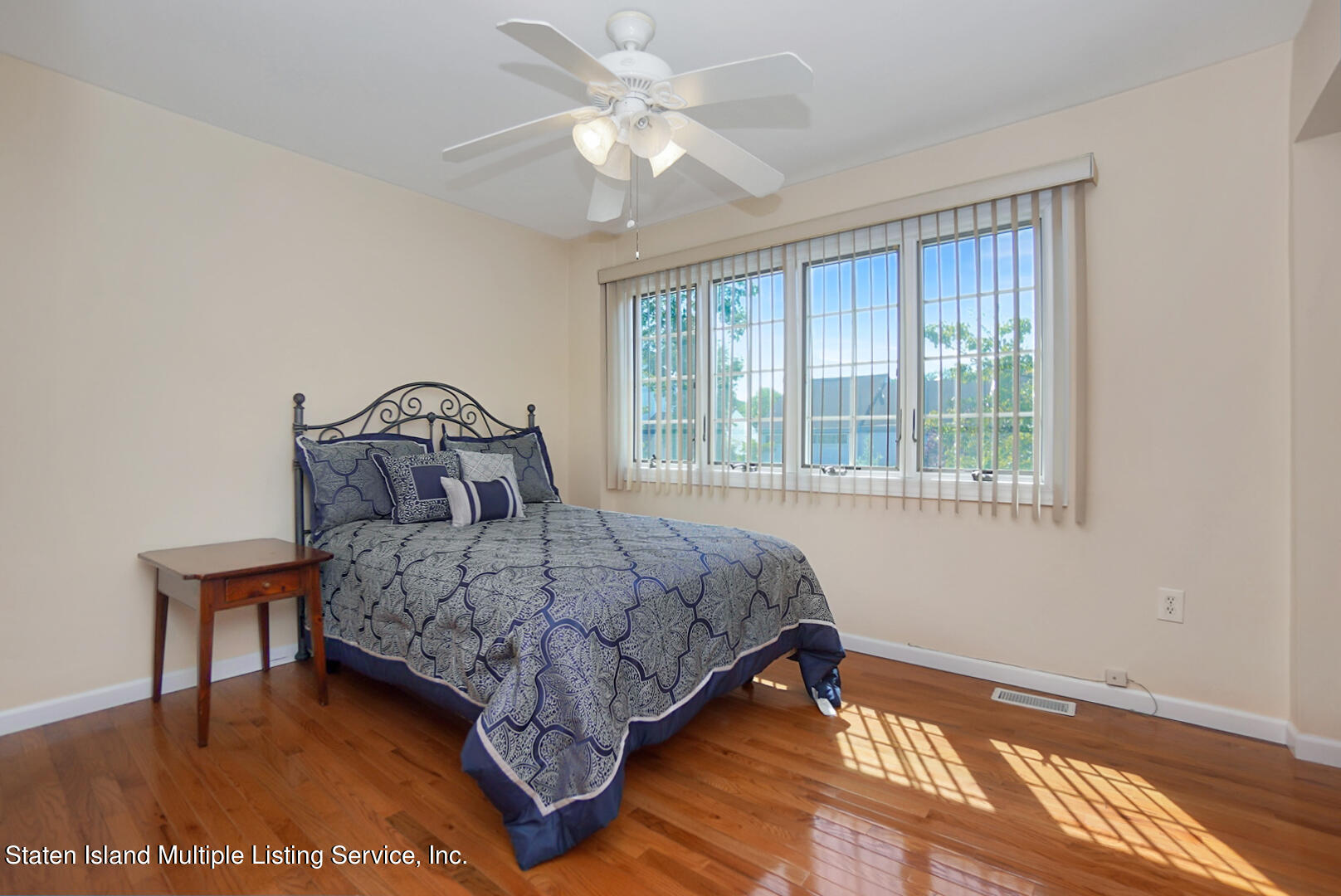 96 Hampton Green Staten Island, NY 10312 - Photo 18 of 24 a bedroom with a bed a chandelier and a window