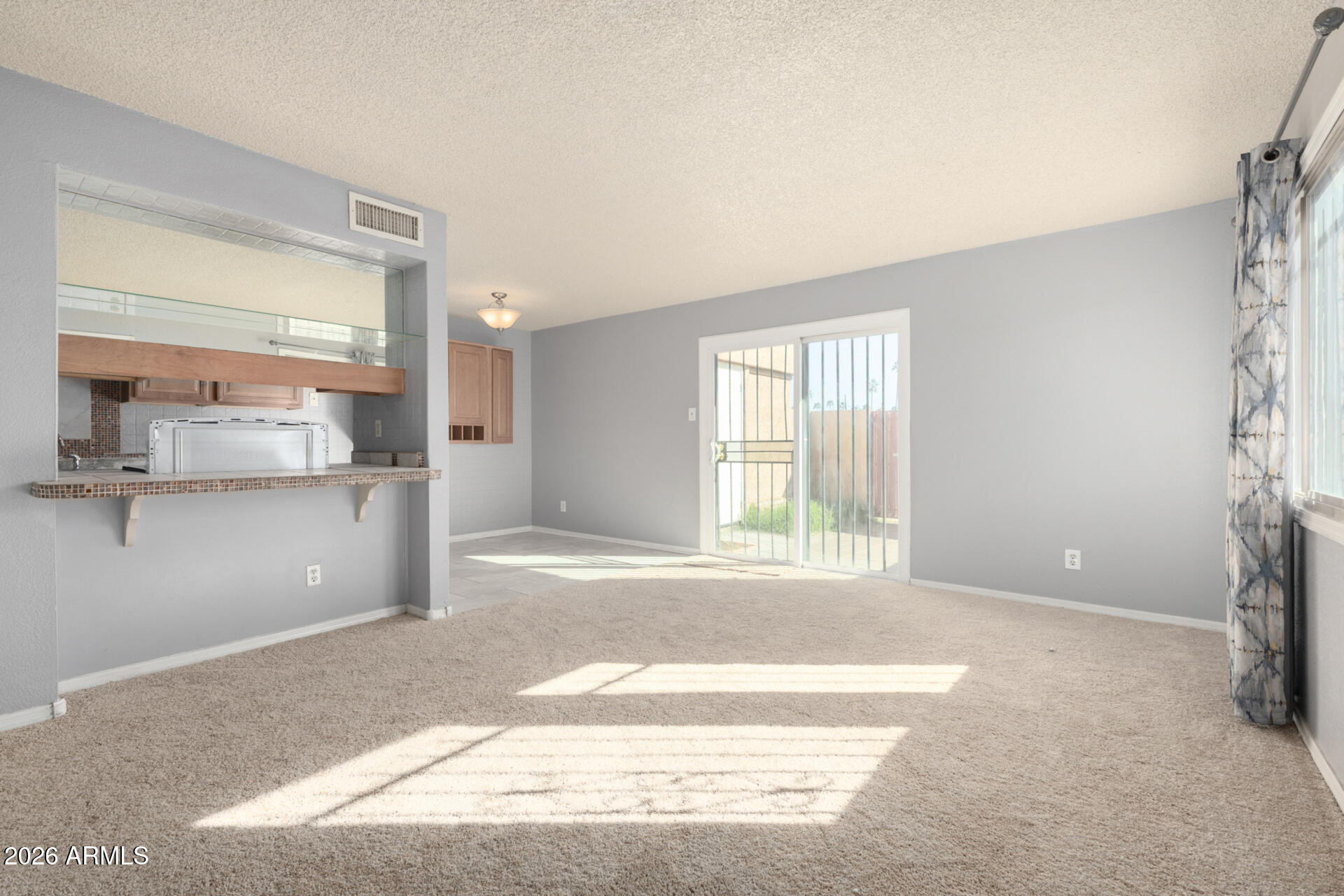 3936 West Camelback Road Phoenix, AZ 85019 - Photo 3 of 19 a view of an empty room with a window